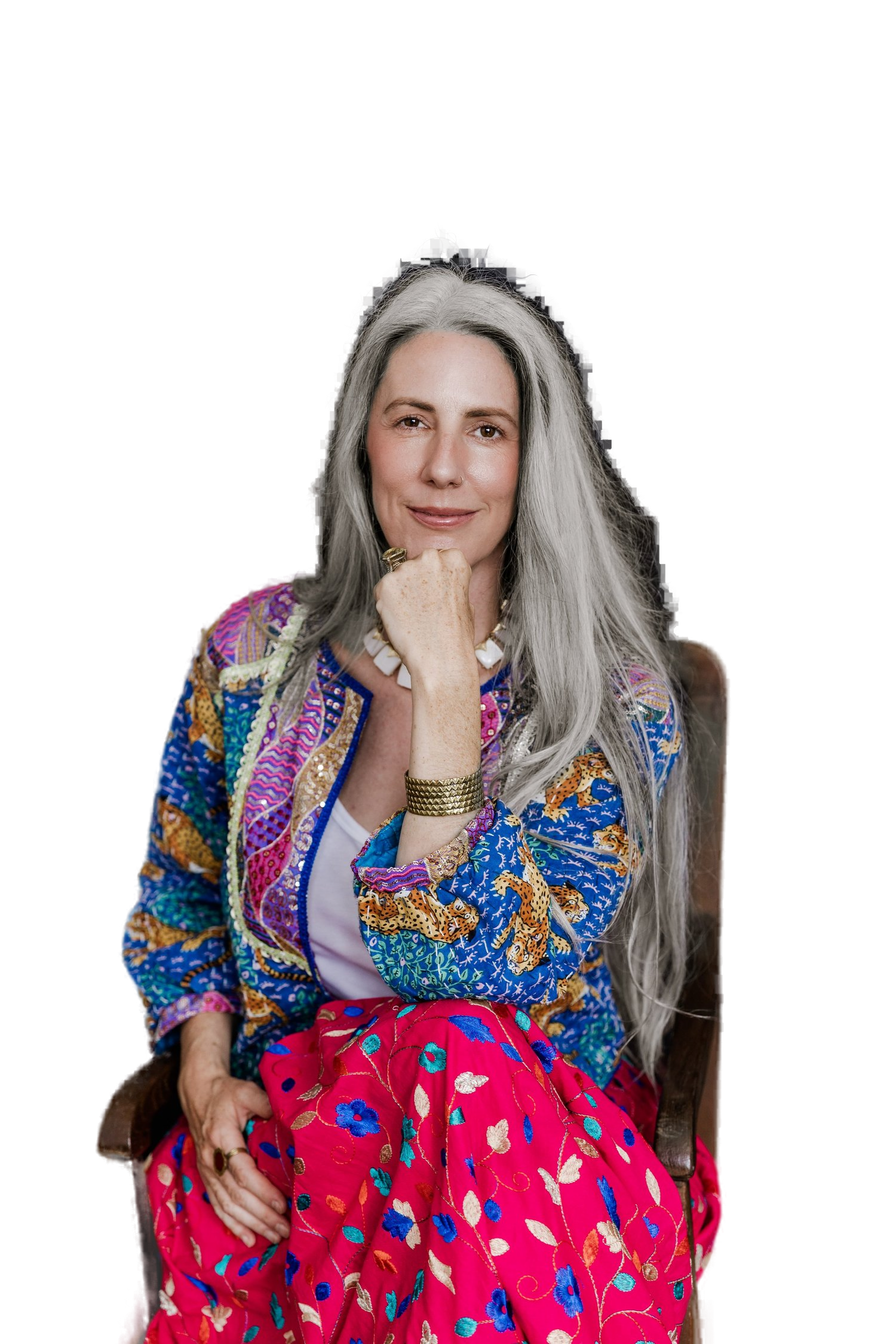 Helen Fehr, astrologer and artist, wearing a vibrant blue patterned jacket with silver hair